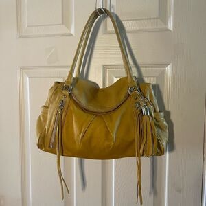 BOTKIER leather mustard yellow shoulder bag tassel accent.Silver tone hardwares